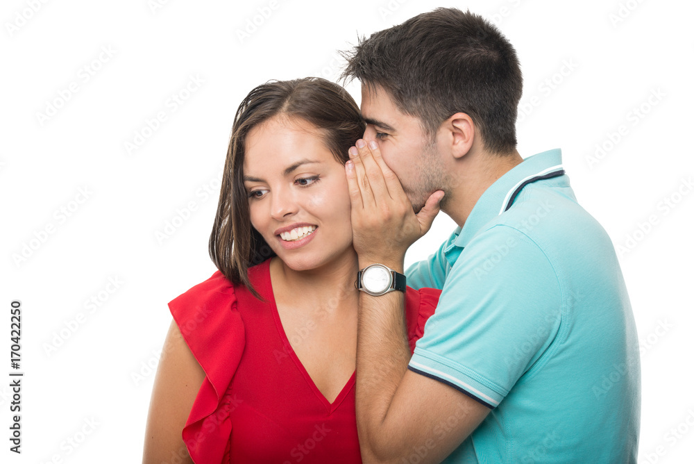 Boyfriend whispering something to girlfriend's ear Boyfriend whispering something to girlfriend's ear
