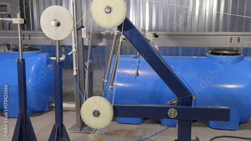 Production of cable products. Rollers a tension of a ready cable before winding on the coil.