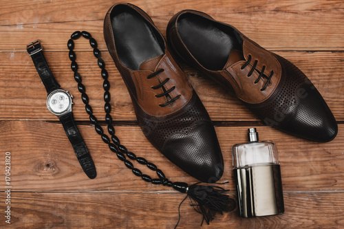 classic men s accessories on the brown table. stylish men s accessories on the wooden background.