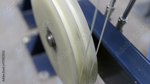 Production of cable products. Rollers a tension of a ready cable before winding on the coil.