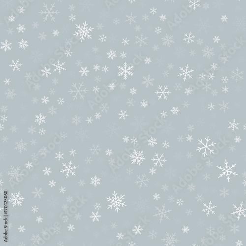 White snowflakes seamless pattern on light grey Christmas background. Chaotic scattered white snowflakes. Magnetic Christmas creative pattern. Vector illustration.