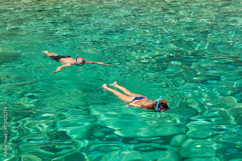 Persons snorkeling near keri blue caves bay in Zakynthos (Zante) island, in Greece