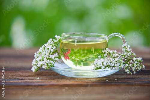 Crystal cup with green tea on table