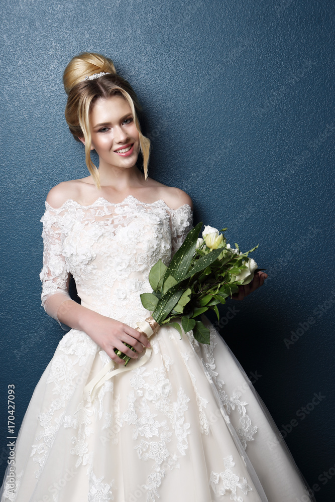 Young beautiful bride. Wedding hairstyle, blond hair, wedding dress, makeup and bride's bouquet. Young beautiful bride. Wedding hairstyle, blond hair, wedding dress, makeup and bride's bouquet.