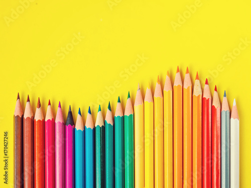 Colored pencil on yellow paper background for drawing color circle