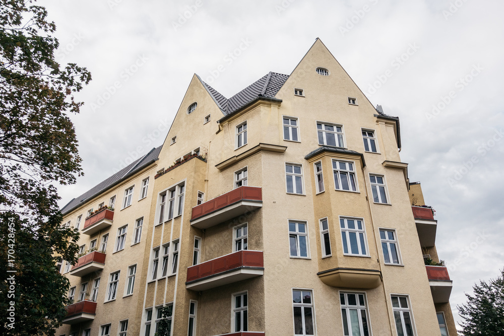 yellow corner house on a cloudy day