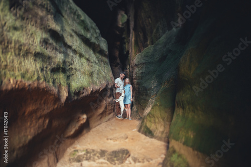 Romantic newlywed couple walking by country side in mountains