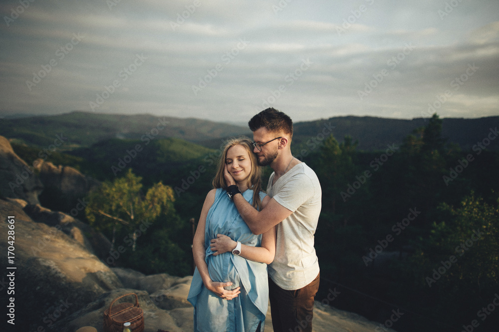 Young dad gently stroking the belly of his pregnant wife Young dad gently stroking the belly of his pregnant wife