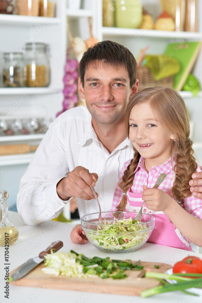 father and daughter preparing salad father and daughter preparing salad