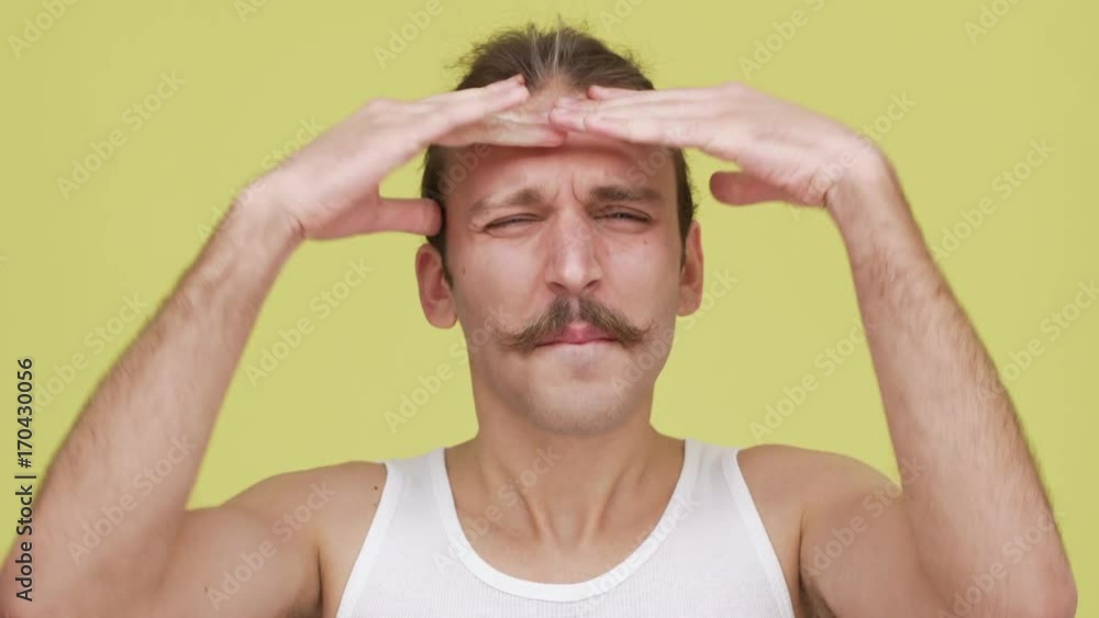 interesting young man with mustaches expressing excitement over yellow background closeup. Concept of emotions interesting young man with mustaches expressing excitement over yellow background closeup. Concept of emotions