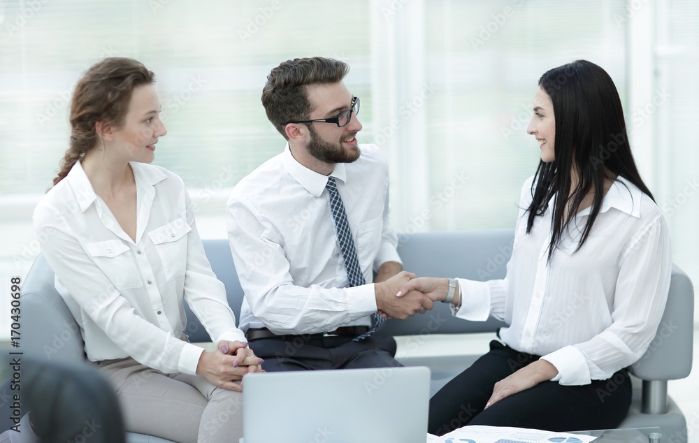 handshake of manager and client in the office lobby