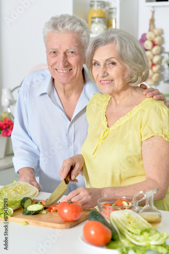 senior couple cutting vegetable