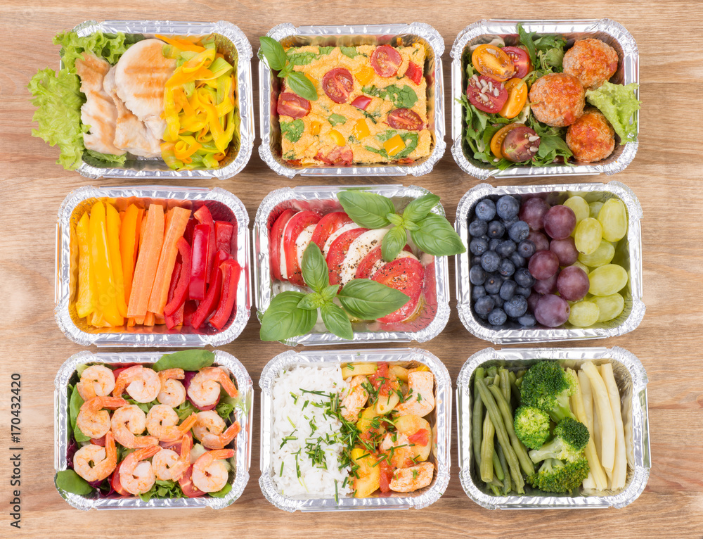 Healthy meals and salads in boxes on wooden table, top view Healthy meals and salads in boxes on wooden table, top view