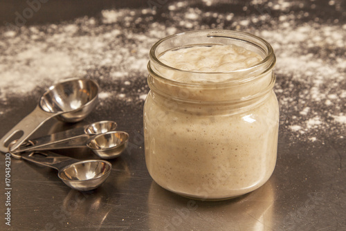sourdough starter with measuring spoons
