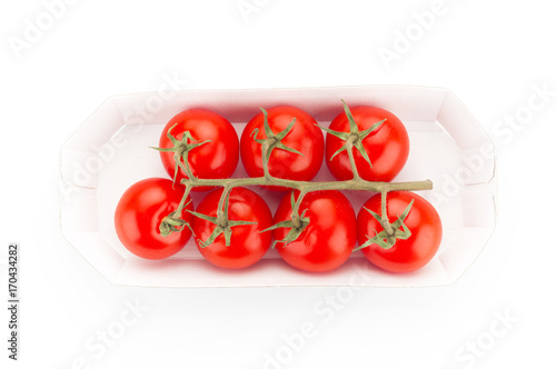 Cherry tomatoes in box on white background © unclepodger