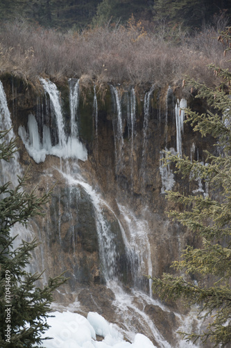 Waterfall on rocks in a coniferous forest