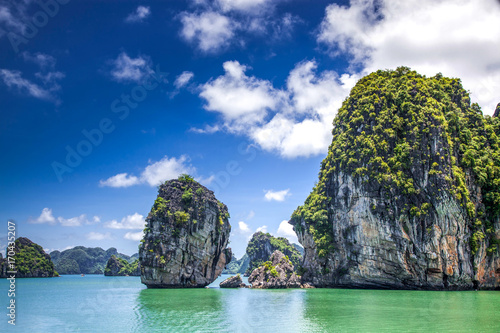 cruising among beautiful limestone rocks and secluded beaches in Ha Long bay, UNESCO world heritage site, Vietnam