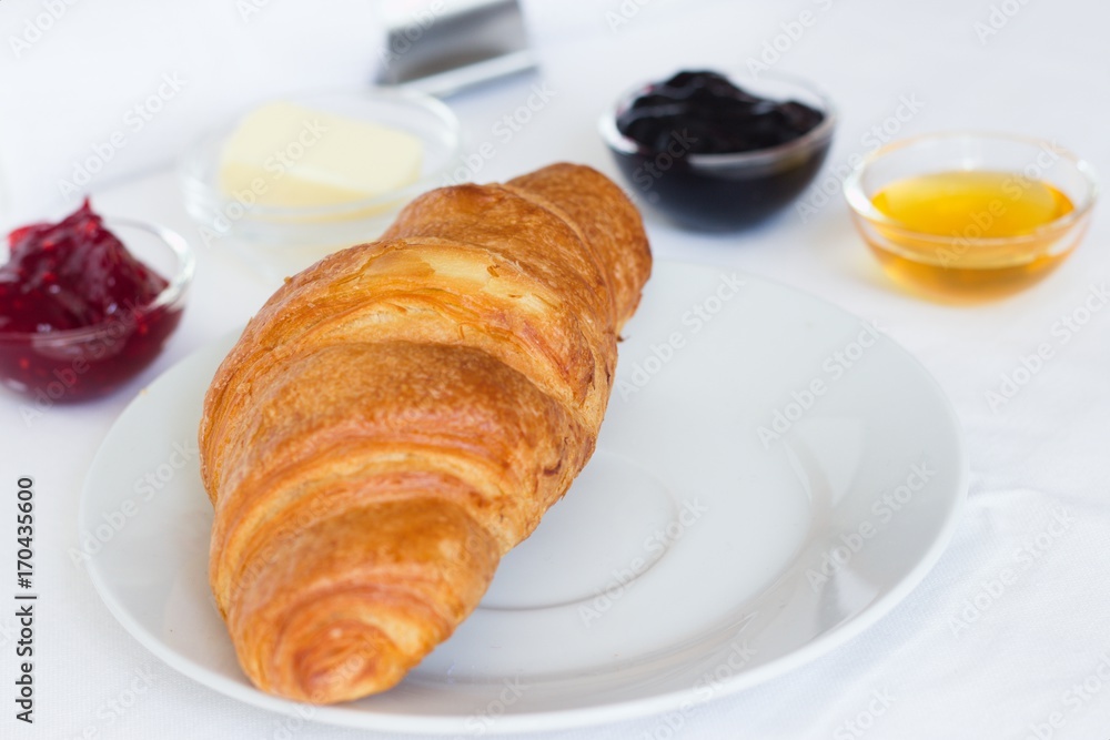 Croissant, jams, butter and honey Croissant, jams, butter and honey