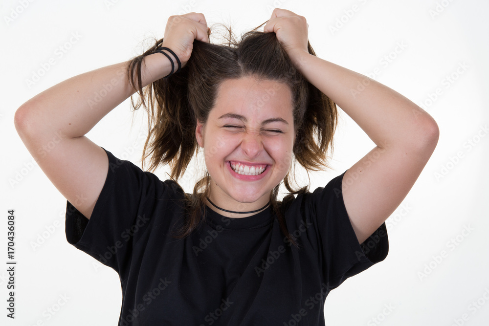 portrait teenager girl on a white background hands in hair for fun attitude portrait teenager girl on a white background hands in hair for fun attitude