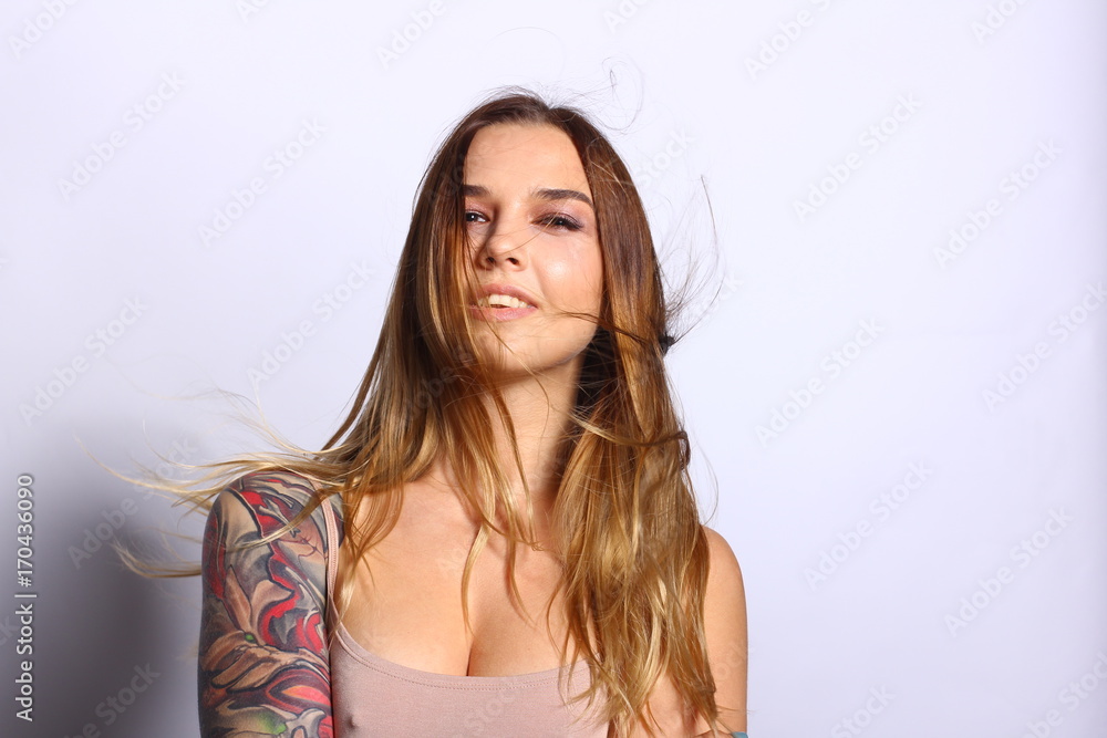 Beautiful woman face with natural skin. Perfect makeup. Wavy brunette hair. Beautiful  tattoo on woman hand. Stock Photo | Adobe Stock