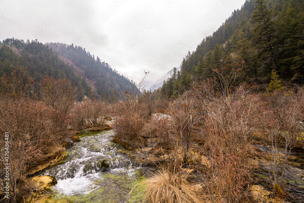 Autumn waterfall on a mountainside in the forest Autumn waterfall on a mountainside in the forest