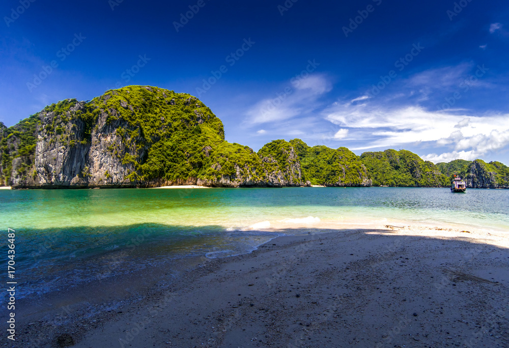 beautiful secluded beaches among limestone rocks on a sunny day in Lan Ha bay, the miniature Ha Long bay, Vietnam