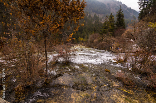 Autumn waterfall on a mountainside in the forest