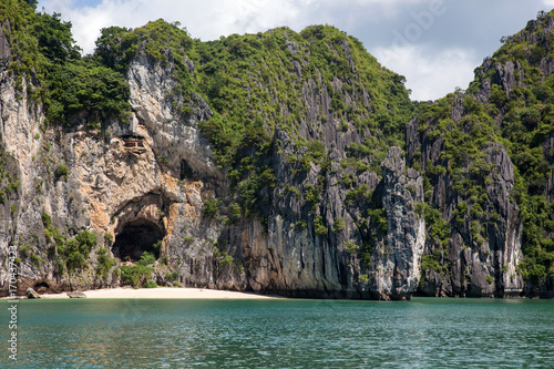 cruising among beautiful limestone rocks and secluded beaches in Ha Long bay, UNESCO world heritage site, Vietnam