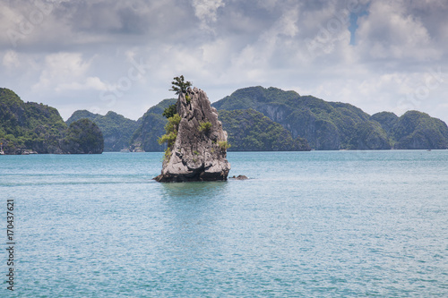 cruising among beautiful limestone rocks and secluded beaches in Ha Long bay, UNESCO world heritage site, Vietnam