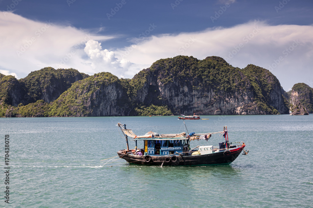 cruising among beautiful limestone rocks and secluded beaches in Ha Long bay, UNESCO world heritage site, Vietnam cruising among beautiful limestone rocks and secluded beaches in Ha Long bay, UNESCO world heritage site, Vietnam