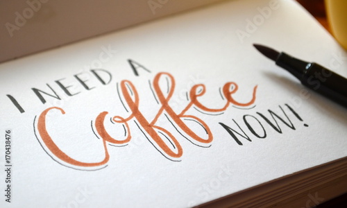 Valokuva I NEED A COFFEE NOW hand lettered in notebook