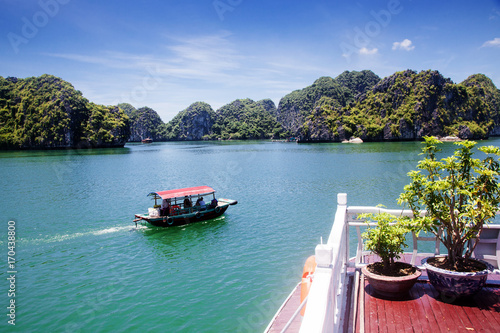 cruising among beautiful limestone rocks and secluded beaches in Ha Long bay  UNESCO world heritage site  Vietnam