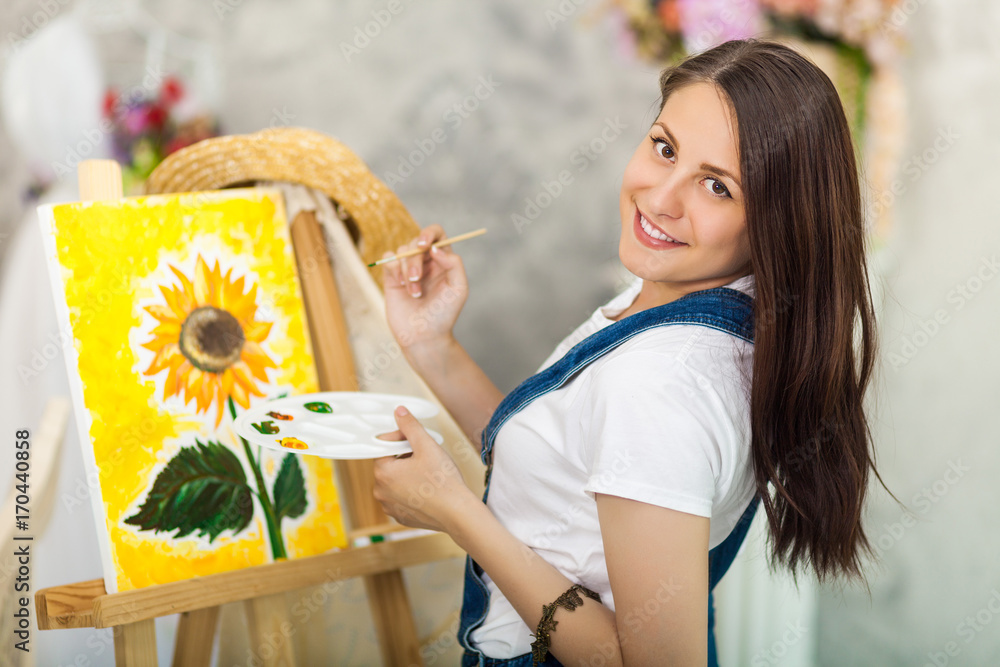 Fototapeta premium Portrait of gorgeous woman artist painting at home