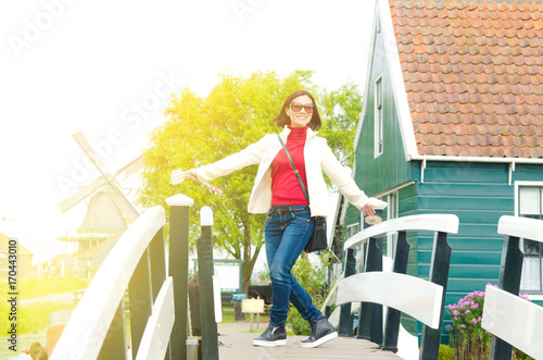 Photography Asian woman enjoyed her holiday in Zaanse Schans, Netherlands