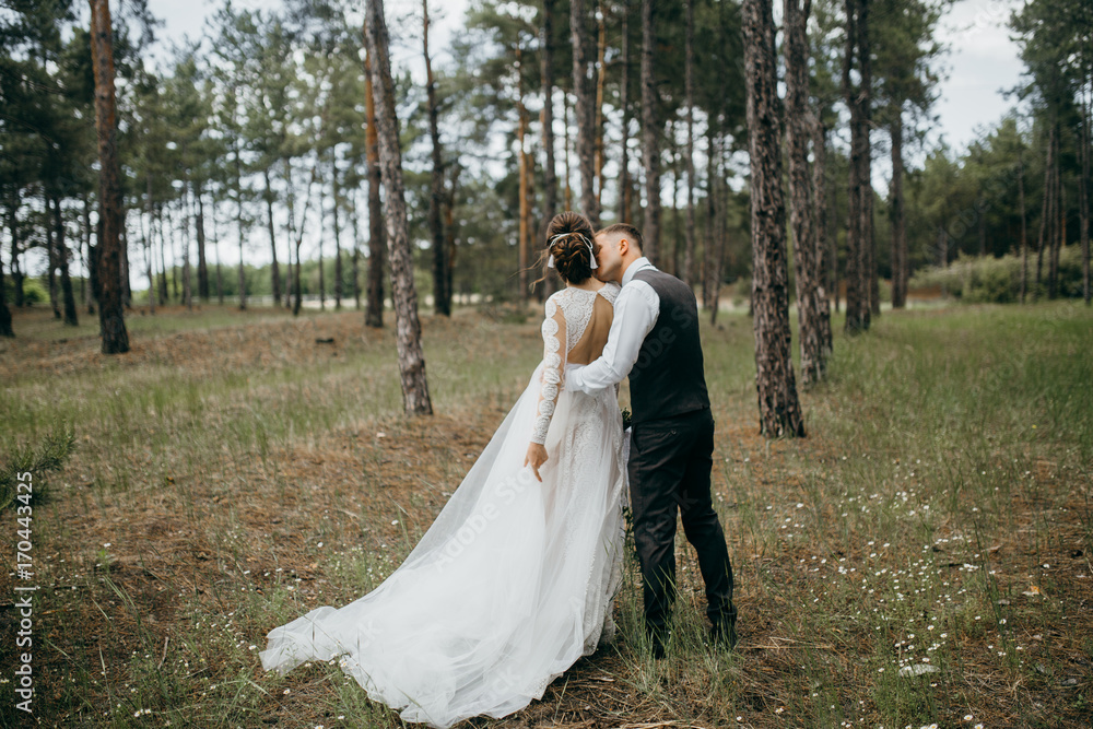 Happy and smiled wedding couple in the forest Happy and smiled wedding couple in the forest