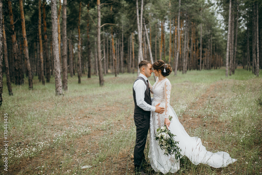 Happy and smiled wedding couple in the forest Happy and smiled wedding couple in the forest
