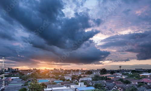Sunset with cloudy sky over the city © nithid18