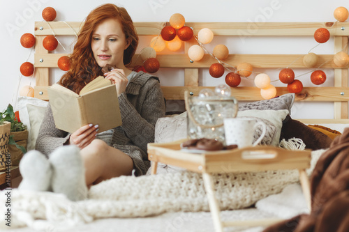 Woman eating gingerbread cookies photo