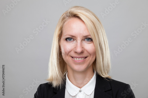 Headshot of young and happy business woman photo