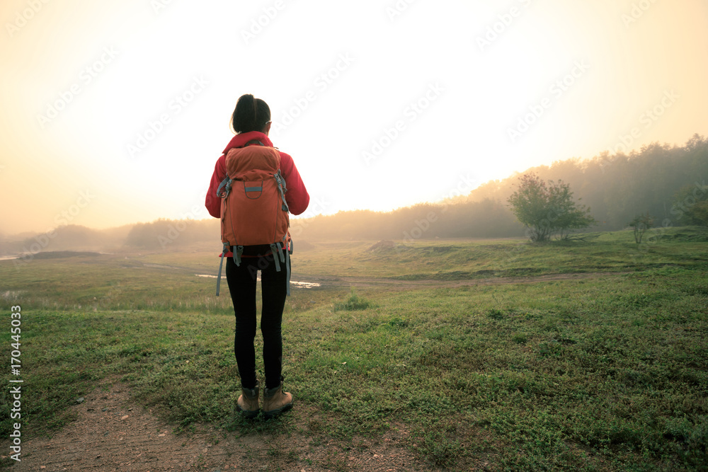 Tourist with backpack in the sunrise nature Tourist with backpack in the sunrise nature