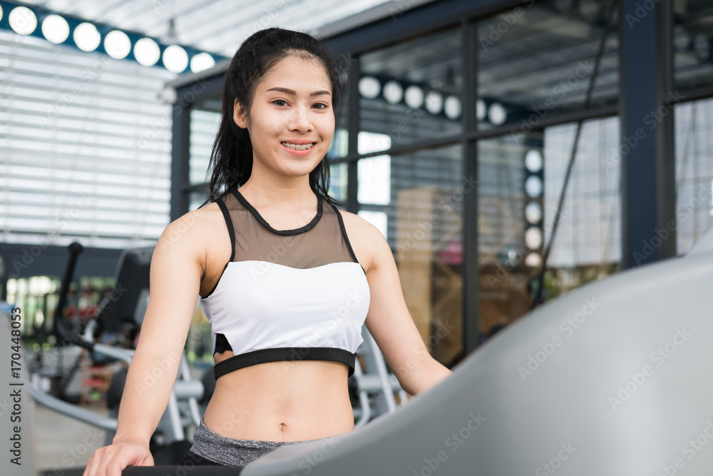 young woman execute exercise in fitness center. female athlete walking on treadmill in gym. sporty girl working out in health club. young woman execute exercise in fitness center. female athlete walking on treadmill in gym. sporty girl working out in health club.