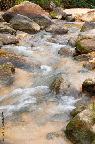 sweet water stream runs around the rocks in the rain forest