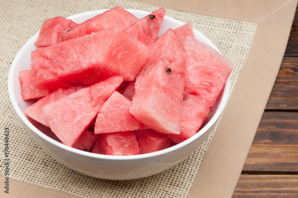 watermelon slices in plate on cloth textured background watermelon slices in plate on cloth textured background