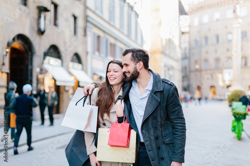 Happy young couple couple shopping in the streets of Florence