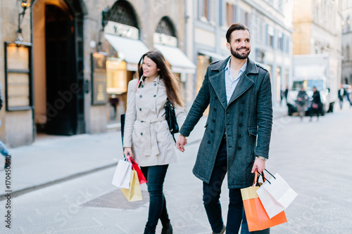 Happy young couple couple shopping in the streets of Florence