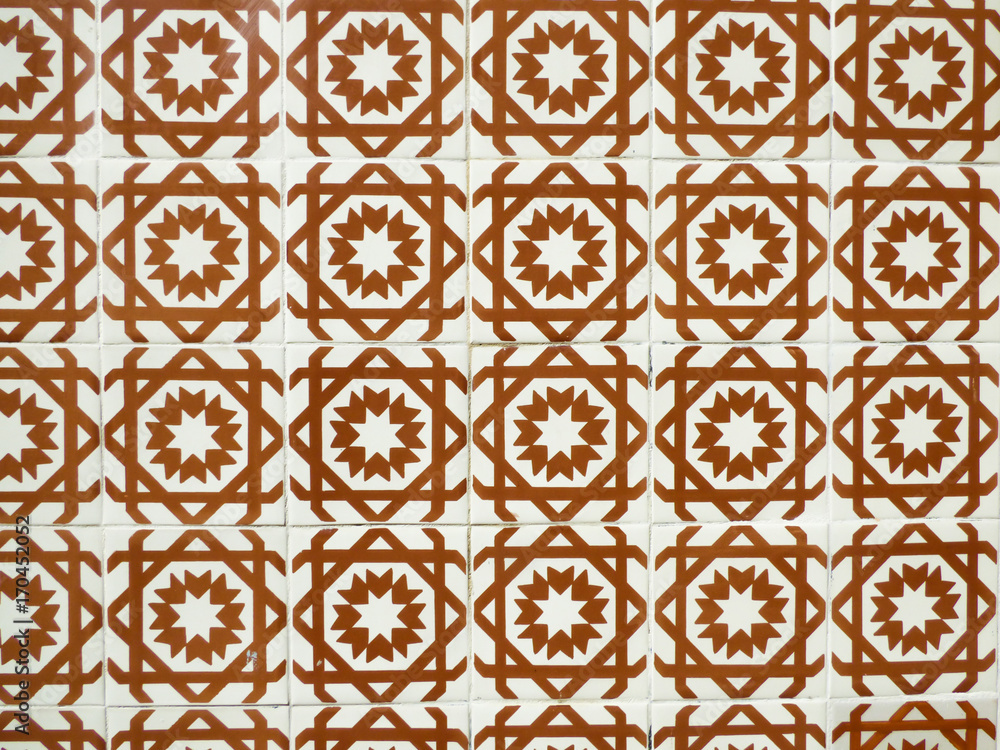 Orange and white Portuguese tiles (azulejos) with geometric pattern in Lisbon, Portugal