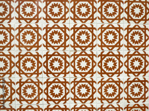 Orange and white Portuguese tiles (azulejos) with geometric pattern in Lisbon, Portugal