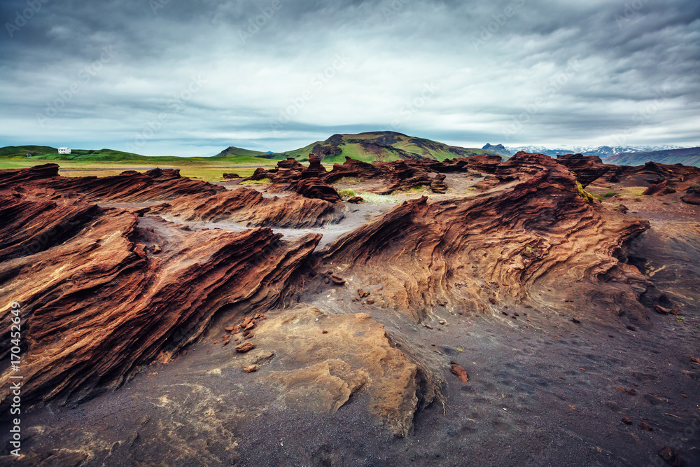 Sandy rocks formed by winds. Location Sudurland, cape Dyrholaey, Iceland, Europe.
