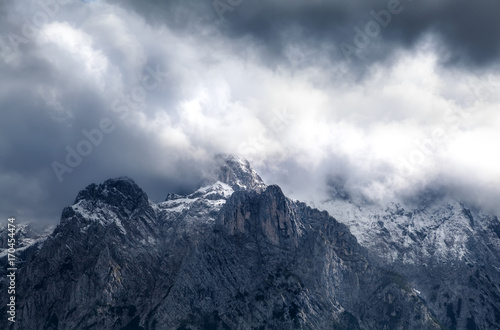 dramatic storm clouds over mountain ridge © Olha Rohulya