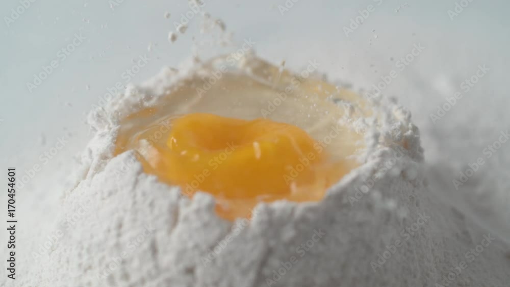 Egg falls on a pile of flour. Shot with high speed camera, phantom flex 4K. Slow Motion. Egg falls on a pile of flour. Shot with high speed camera, phantom flex 4K. Slow Motion.